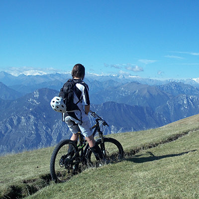 cyclist looking over italian mountains